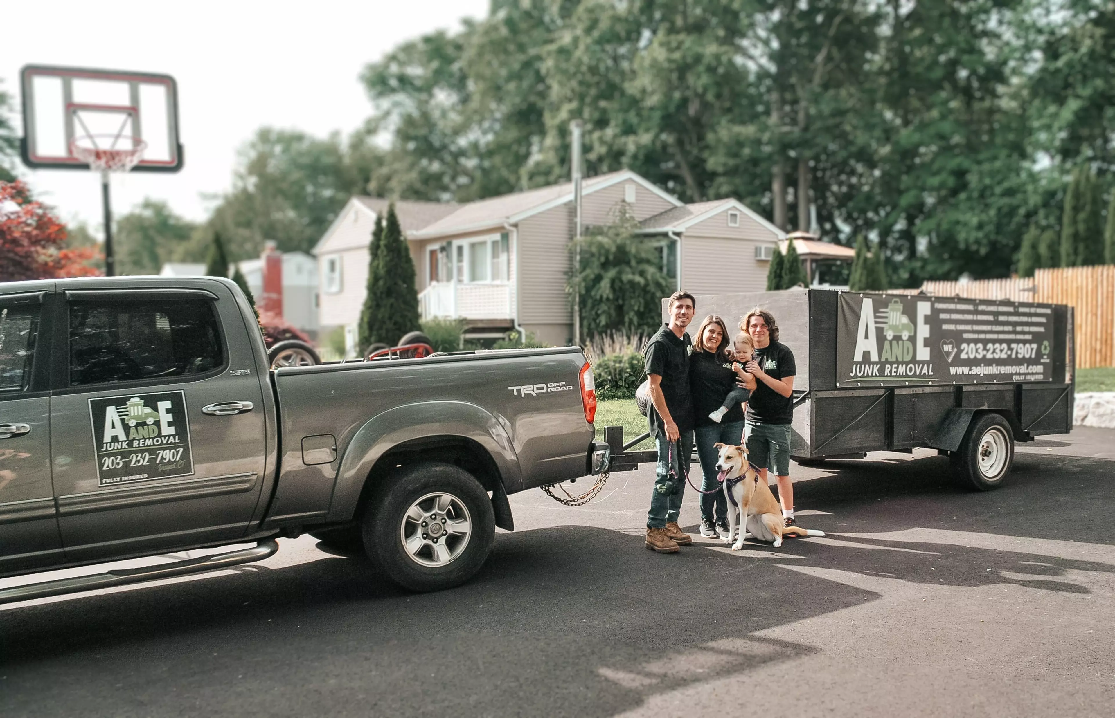 Owner Gary and family standing by A and E Junk Removal truck