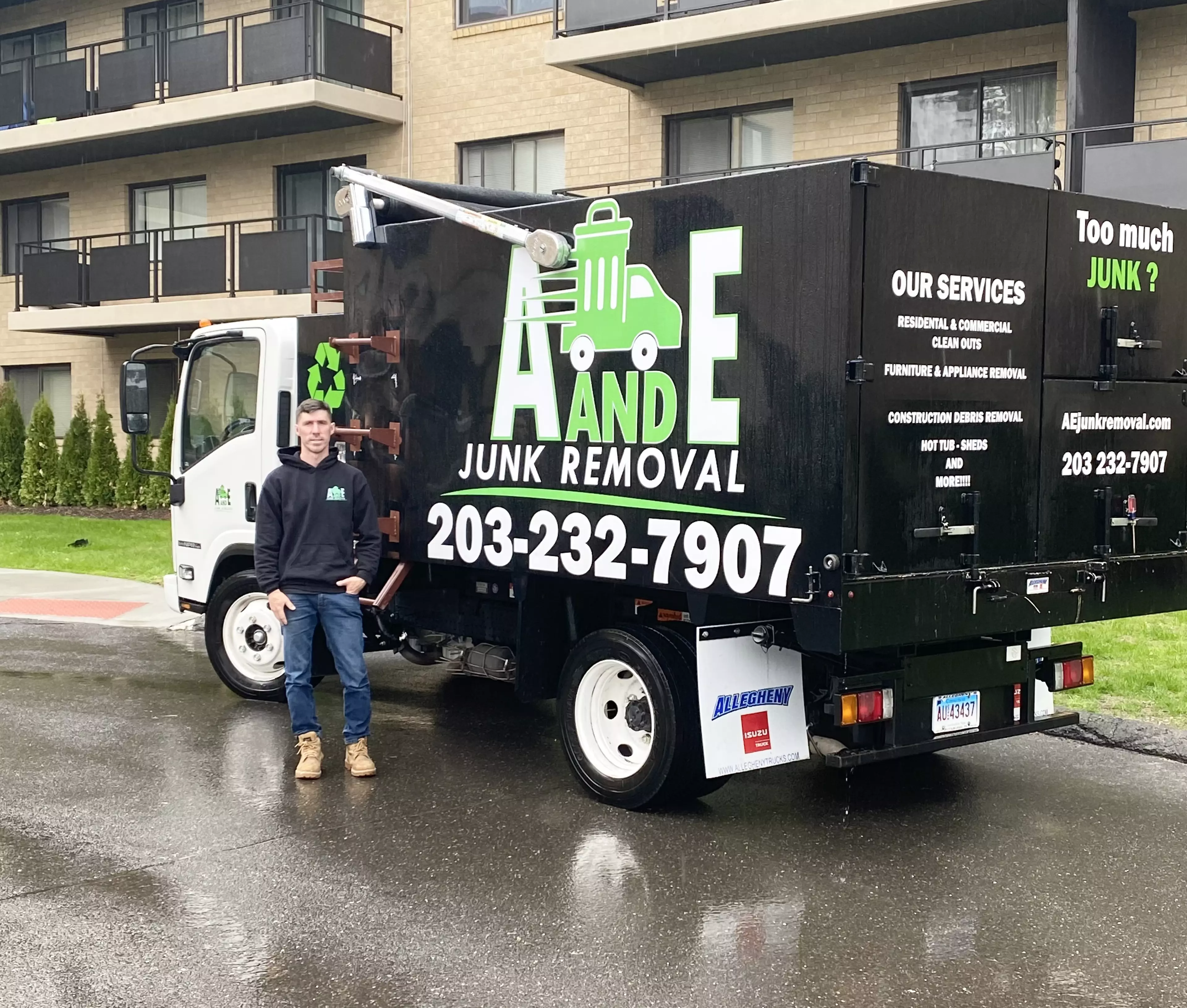 side of the a and e junk removal truck and trailer