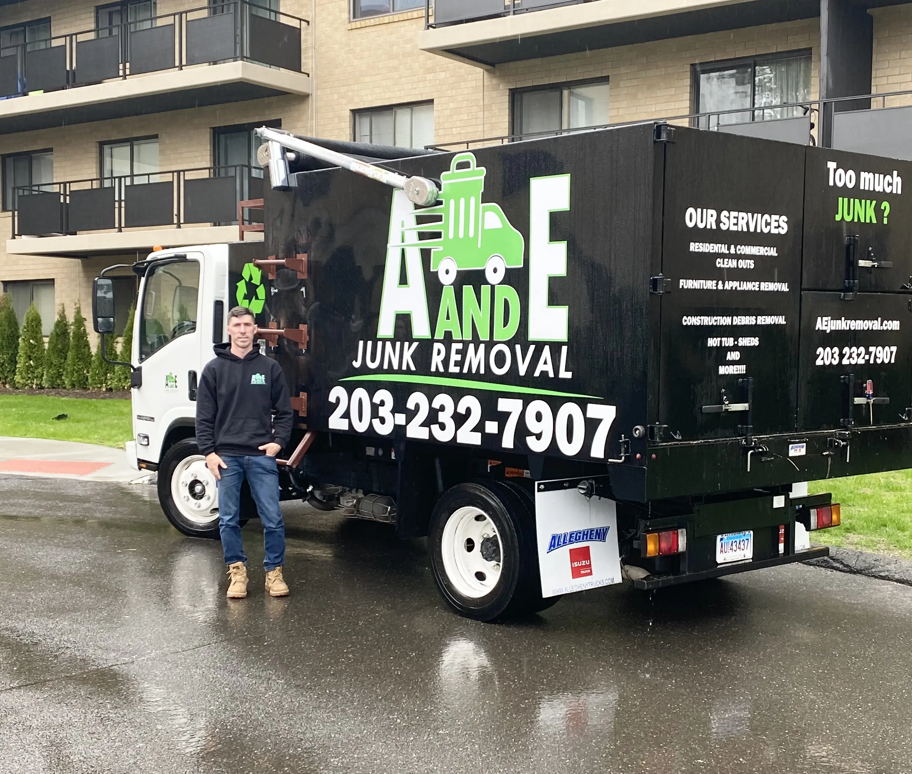 side of the a and e junk removal truck and trailer